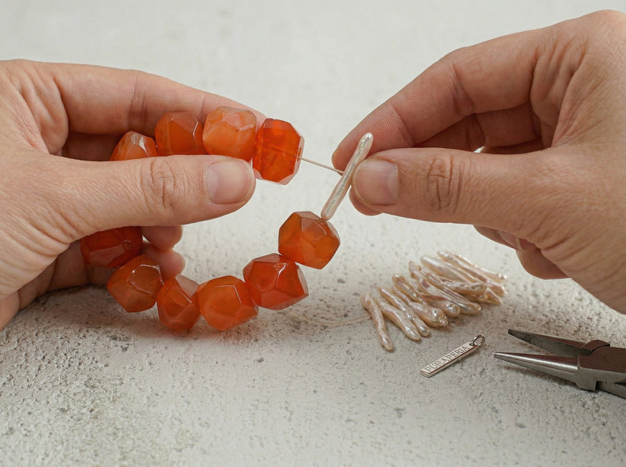 A Kinsoul Energy bracelet being strung stone by stone, balanced and composed by hand