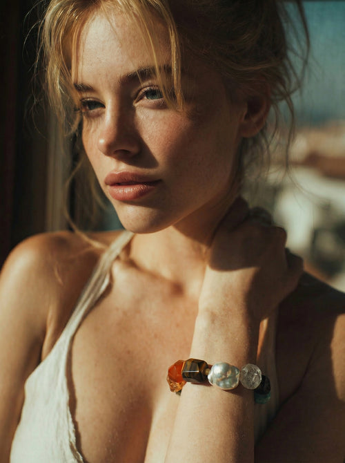 Aura bracelet front view — eight natural gemstones with central baroque pearl